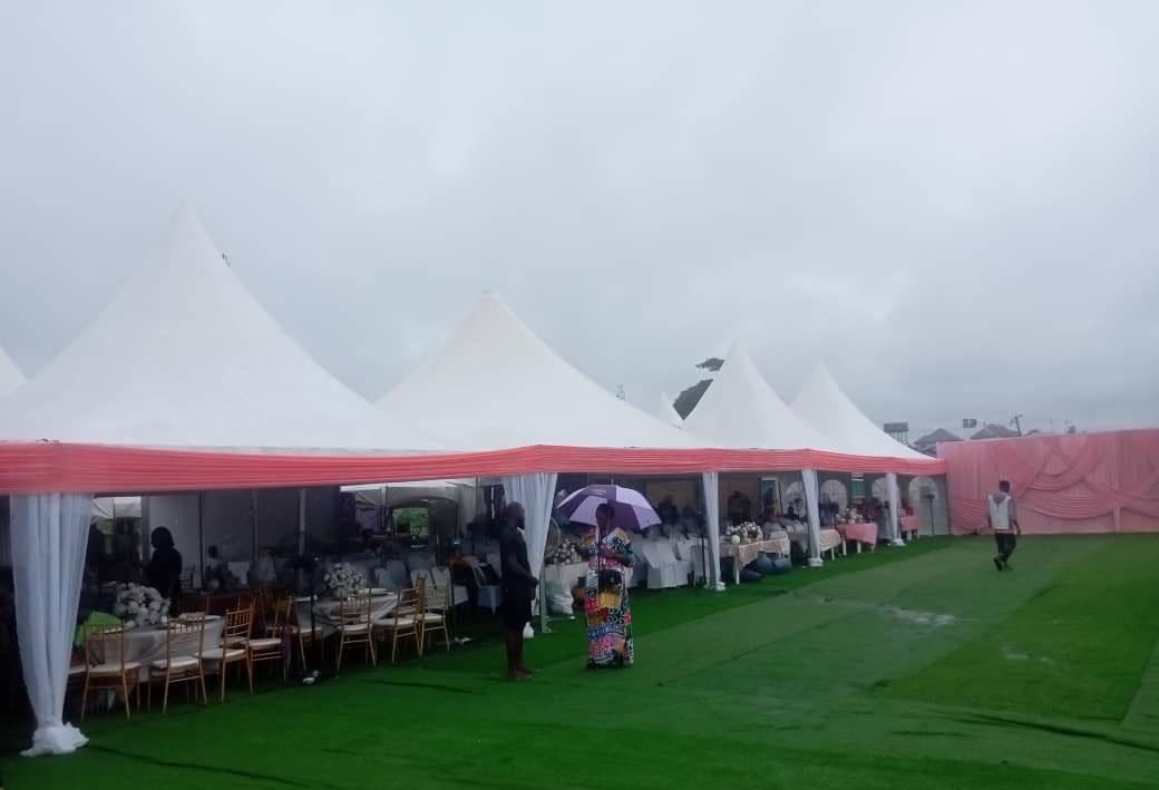 Multi-peak pagoda canopy row on a green lawn.