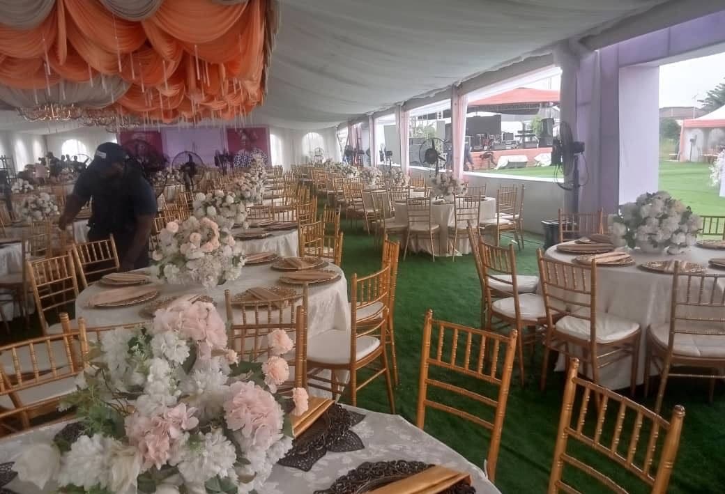 Grand wedding interior with orange and peach ceiling draping.