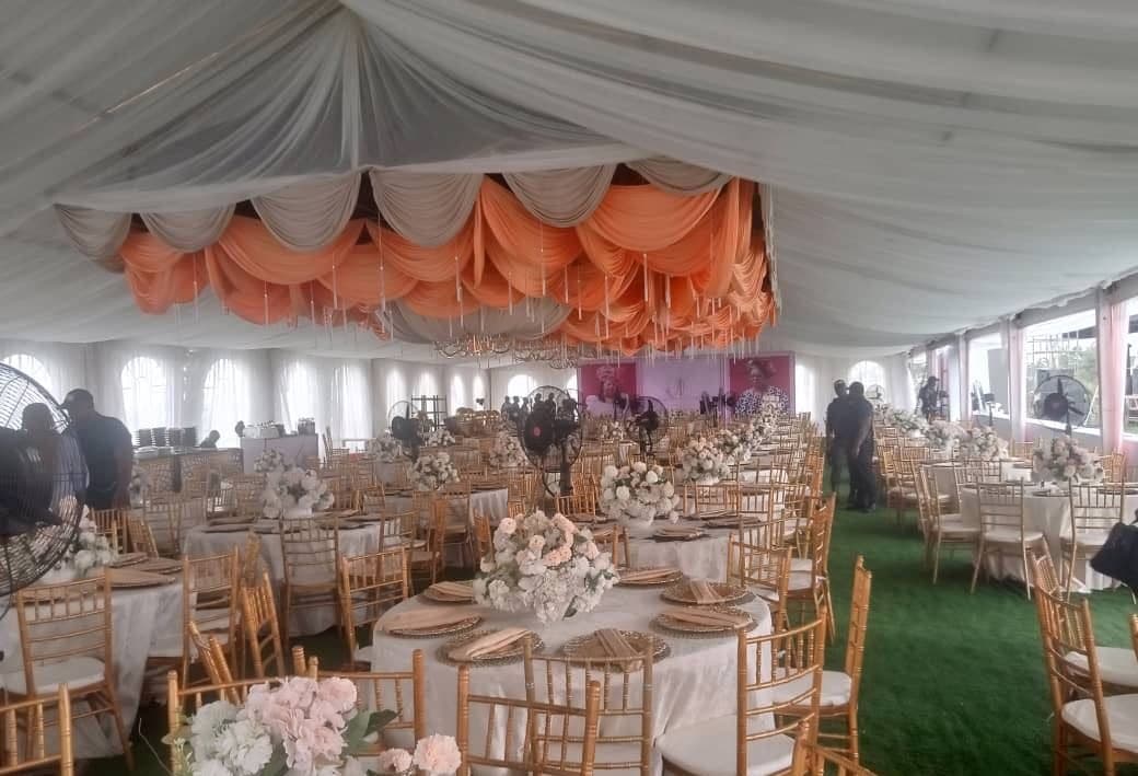Wedding interior with floral centrepieces and round tables.